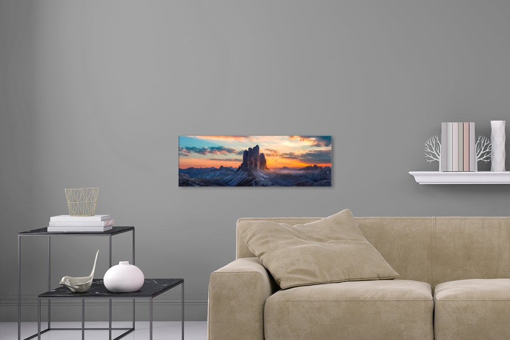 Aufgehängtes Wandbild einer Panorama Fotografie der drei Zinnen in den Alpen bei Sonnenaufgang. Fotokunst online kaufen. Hinter Acrylglas oder als Poster