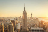 Architektur Fotografie des Empire State Buildigs mit Blick Down Town bei Sonnenuntergang. Fotokunst online kaufen. Wandbild hinter Acrylglas oder als Poster