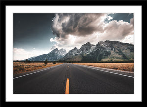Fotografie von einer Straße mit Bergen im Hintergrund und Wolken im Sommer. Fotokunst und Bilder online kaufen. Wandbild im Rahmen